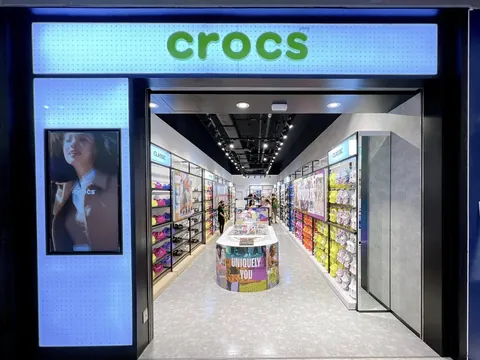 Neon-edge storefront frame and backlit Crocs signage